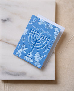 Happy Hanukkah greeting card and white envelope